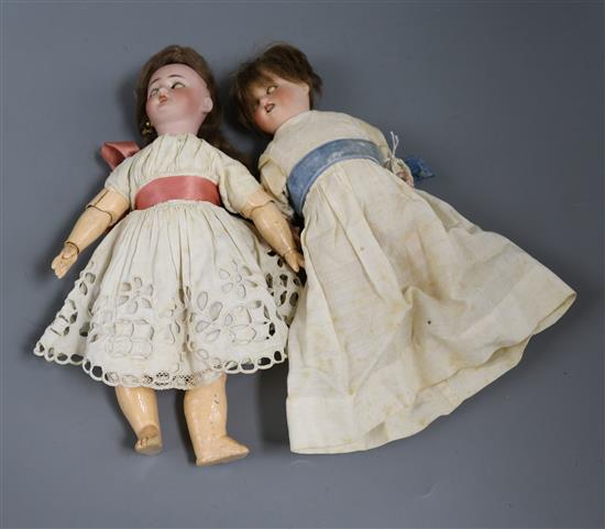 A Herman Steiner boy doll and a Simon and Halbig girl doll with pierced ears, open mouth, original wig and jointed wrists H.9in.